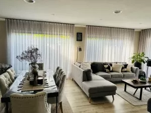living room with floor to ceiling sheer curtains